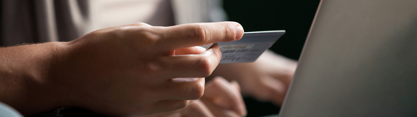 Man using a credit or debit card on a laptop computer