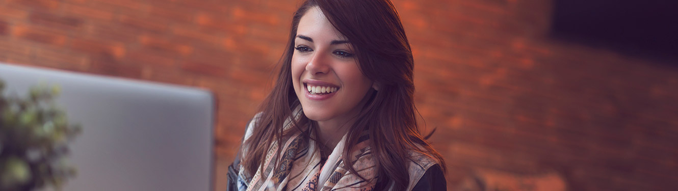 Lady smiling using a laptop computer