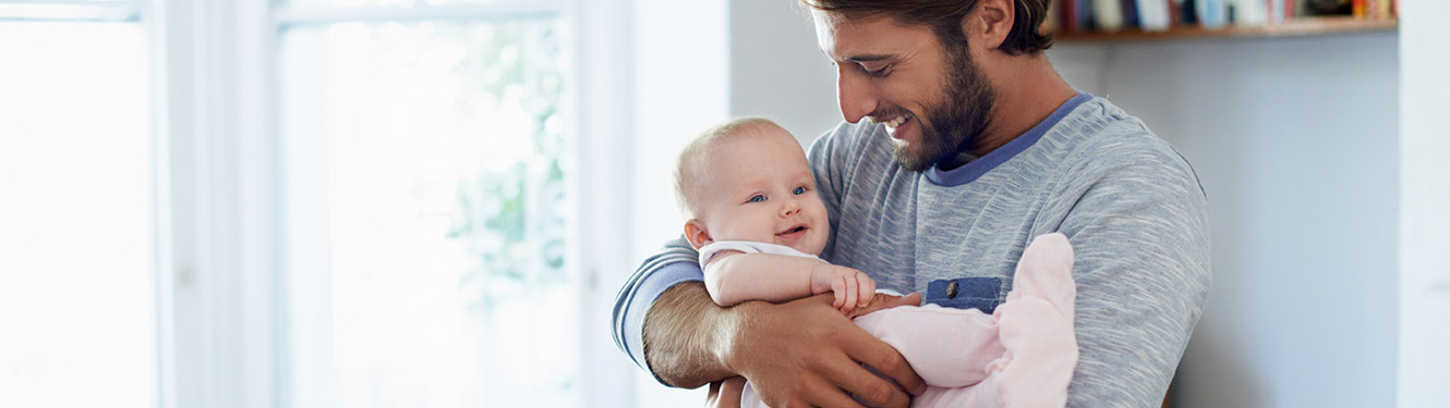 A father holding a baby girl 